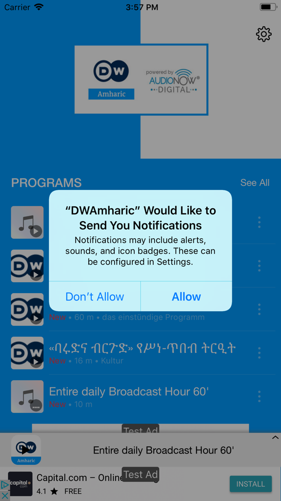 DW Amharic by AudioNow - Solicitud de permiso de notificación de iOS en la pantalla de inicio de la aplicación DW Amharic que muestra la lista de programas