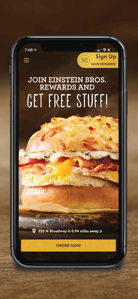Einstein Bros Bagels - Smartphone displaying the Einstein Bros Bagels mobile app with a breakfast sandwich and a call to join rewards to get free stuff.