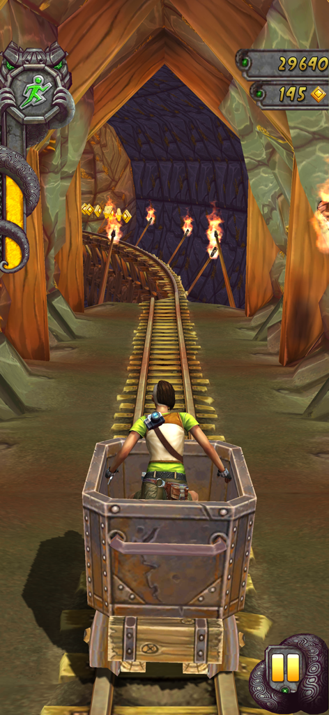 A character riding a mine cart through a rocky tunnel in Temple Run 2
