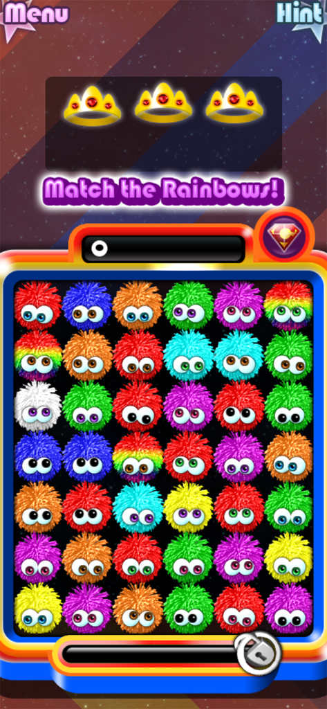 Chuzzle 2 - Gameplay screen of Chuzzle 2 showing a grid of colorful fuzzy characters and a match the rainbows objective