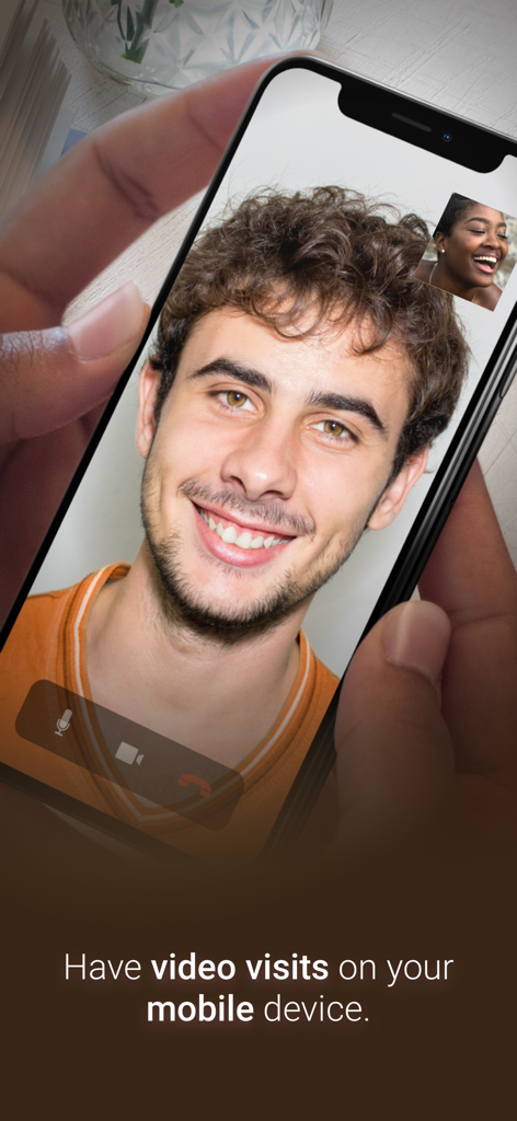 A person using a smartphone for a video call through the GettingOut Visits app