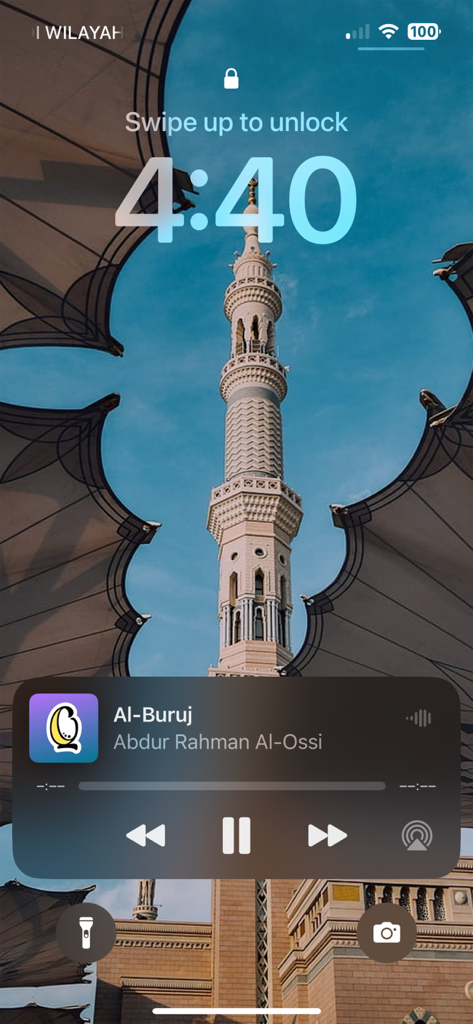 Quran White Noise - Baby Sleep - iPhone lock screen displaying audio controls for the Quran White Noise app with a mosque minaret background.