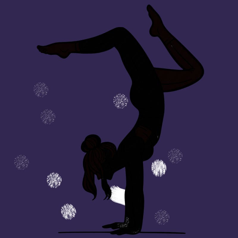a woman doing a handstand