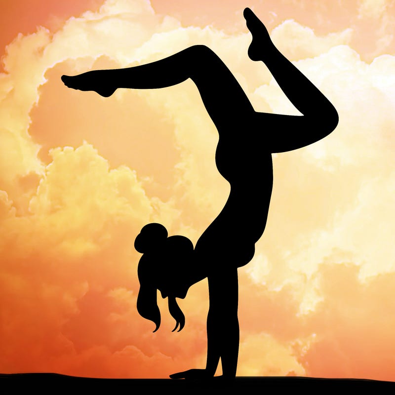 a woman doing a handstand