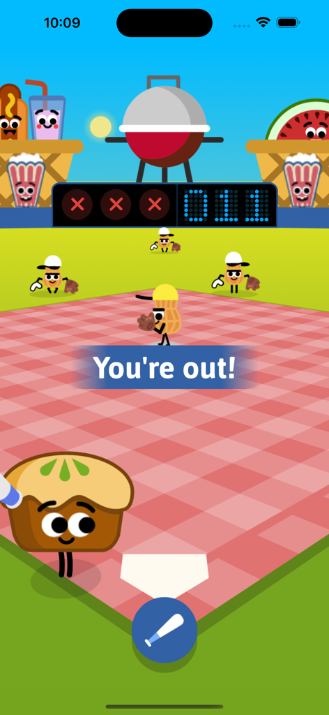 Gameplay screenshot of Doodles Baseball Game featuring food characters playing on a picnic blanket field with a You are out message