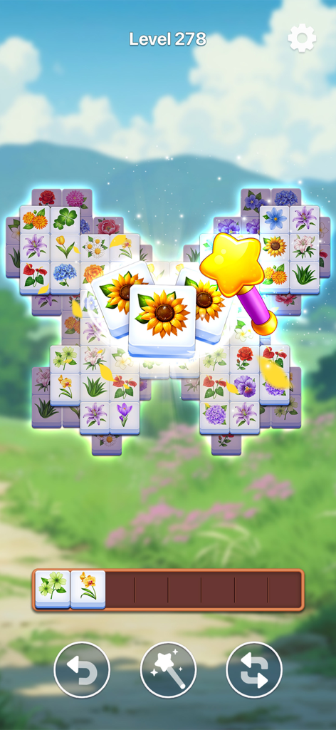 A gameplay screenshot of Bloom Tile showing matching flower tiles on a relaxing garden background.