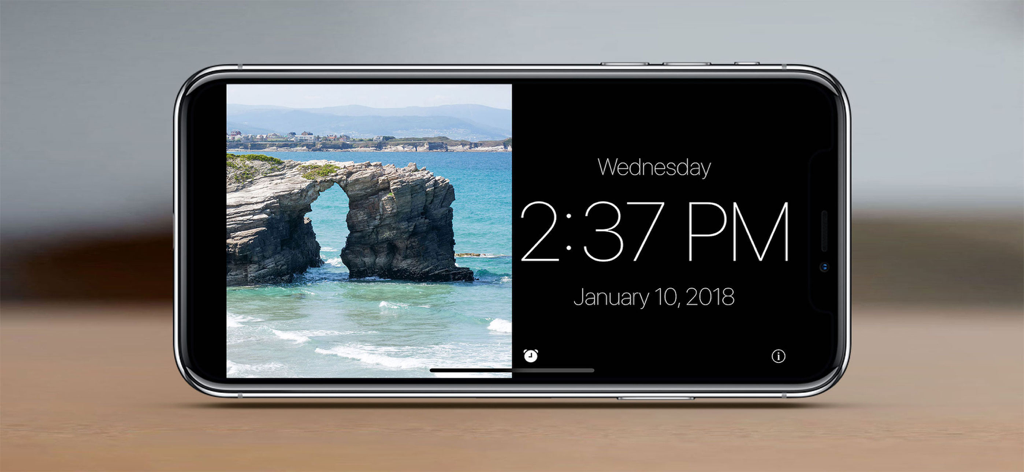 Standby Alarm Clock - iPhone in landscape mode displaying a digital clock alongside a scenic coastal photo.