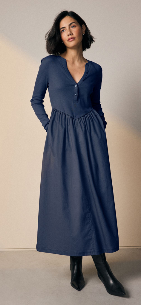 Next: Shop Fashion & Homeware - Woman wearing a navy blue long-sleeved maxi dress with black pointed-toe boots.