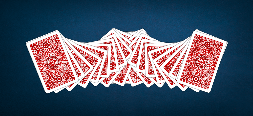 A fanned deck of cards showing the traditional red back design for the Conquian 333 card game on a blue background