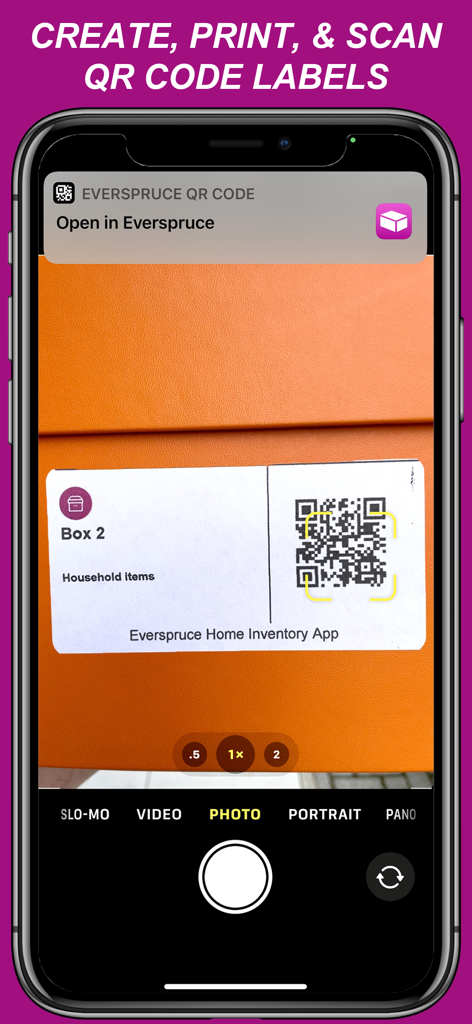 A smartphone scanning a custom QR code label on a storage box using the Everspruce Home Inventory app.