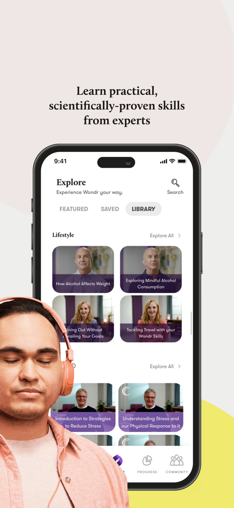 A man wearing headphones listening to expert health coaching videos on the Wondr Health mobile app