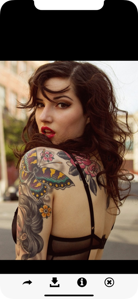 女性の肩に施されたカラフルな蝶とバラのタトゥーデザイン