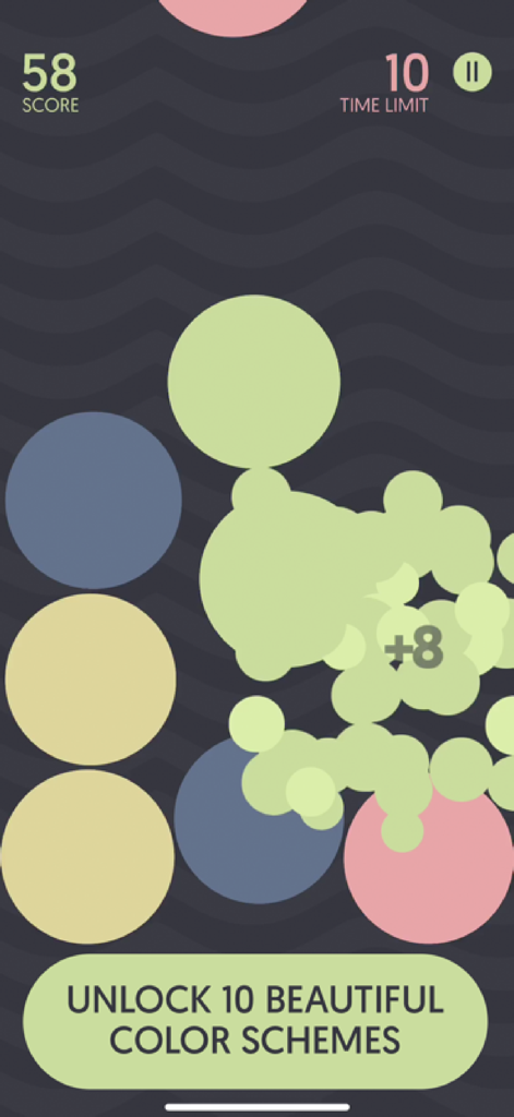 Gameplay of Dream Bubblez showing colorful bubbles bursting and an unlock color schemes banner.