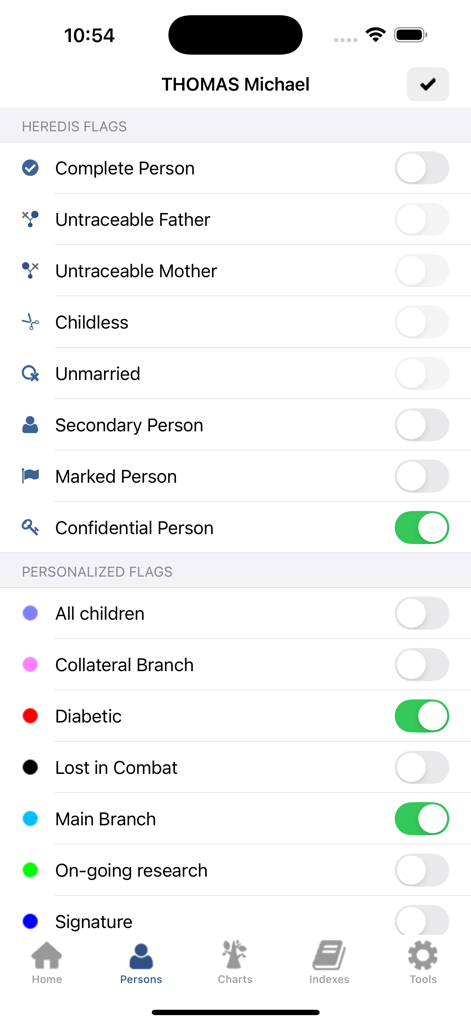 A mobile screen from the Heredis 2026 app showing a list of standard and personalized flags to categorize individuals in a family tree.