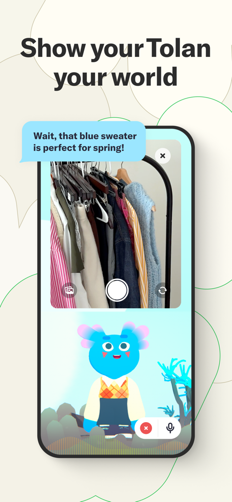 A smartphone showing the Tolan app interface where a blue alien AI comments on a photo of a clothing rack