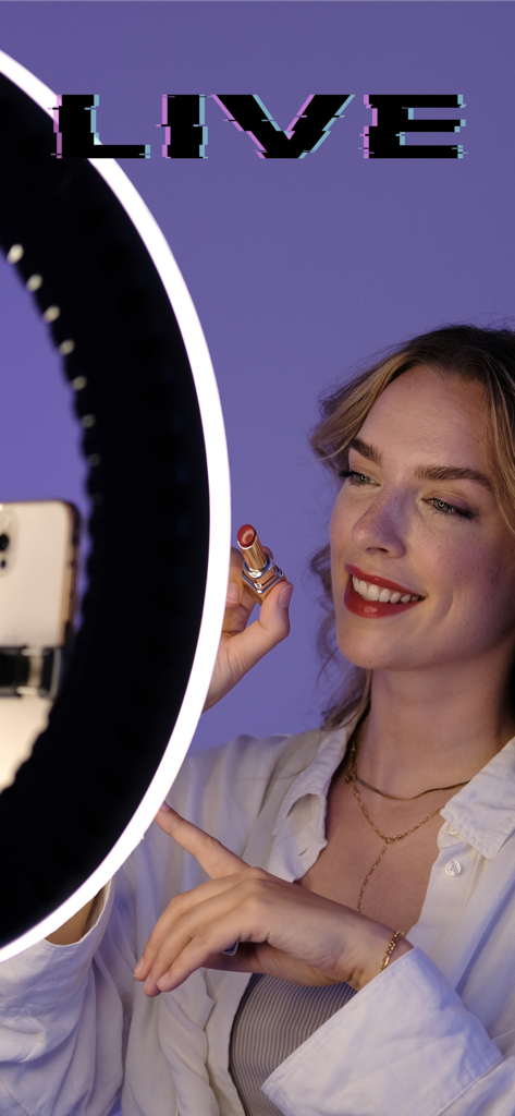 Douglas Creator - A woman beauty creator holding a lipstick while hosting a live stream with a ring light and smartphone
