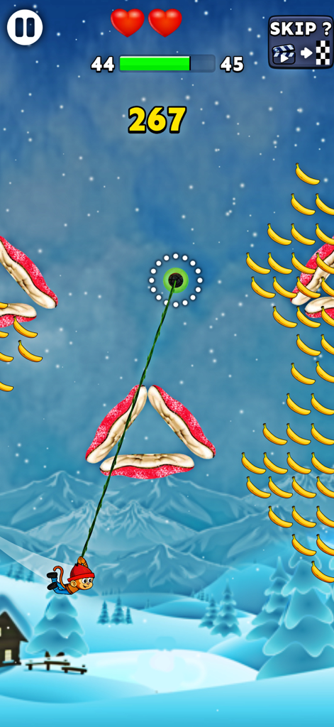 Monkey Hook - No Wifi Game - Un personaje mono balanceándose en una cuerda verde en un nivel de montaña nevada con plátanos y obstáculos