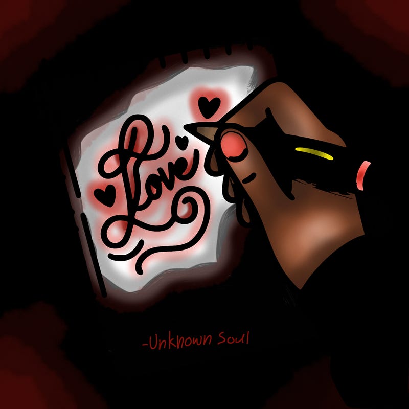 a hand writing “love” in calligraphy on a notebook