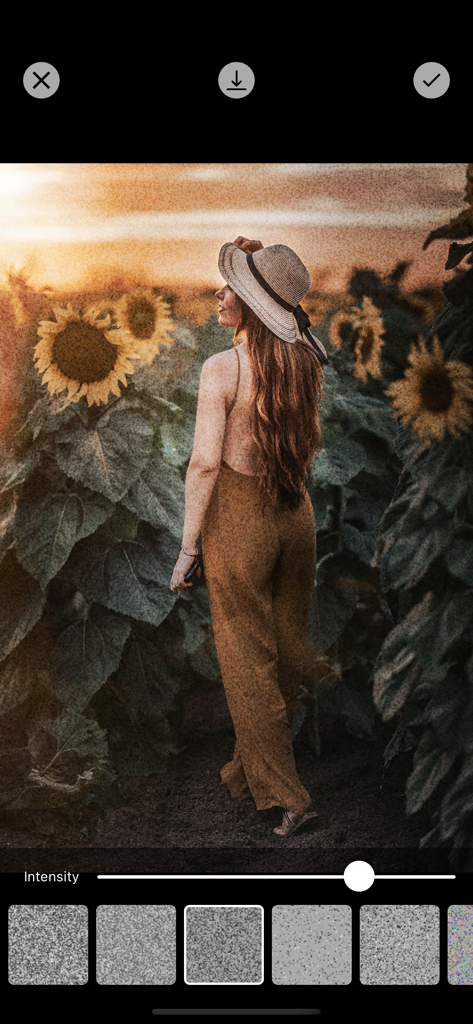 Photo Filters + - Interface of Photo Filters plus app showing a grain filter applied to a photo of a woman in a sunflower field