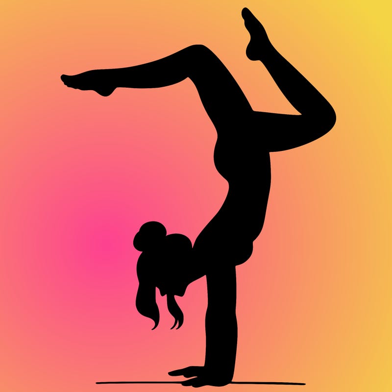 a woman doing a handstand