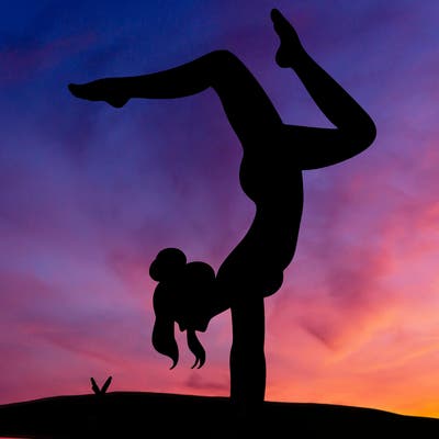 a woman doing a handstand