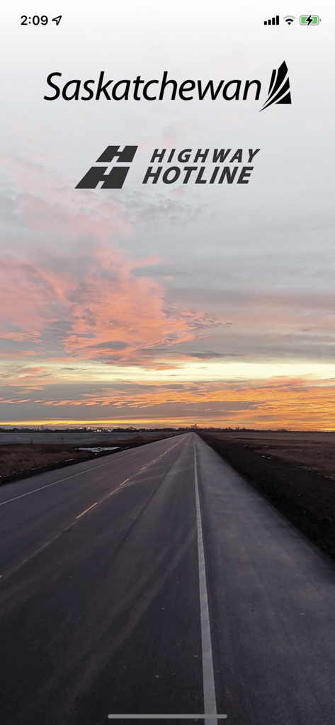 Saskatchewan Highway Hotline app splash screen showing a straight road under a colorful sunrise sky