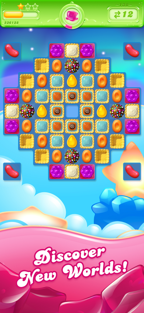Candy Crush Jelly Saga gameplay showing a match-3 puzzle board with colorful candies and the text Discover New Worlds