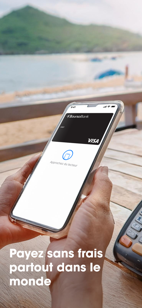 Smartphone displaying a BoursoBank virtual Visa card for contactless payments with a beach background