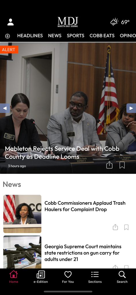 Marietta Daily Journal - Home screen of the Marietta Daily Journal app displaying local news headlines for Cobb County including a featured story about Mableton