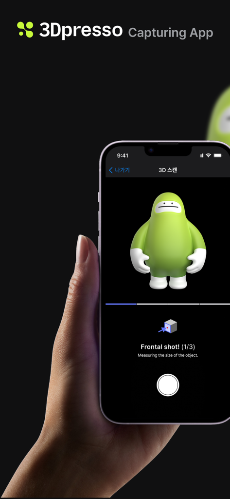 3Dpresso - A hand holding a smartphone using the 3Dpresso app to capture a 3D scan of a green character