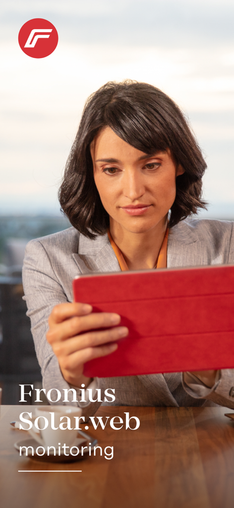 A woman using the Fronius Solar.web app on a tablet for home energy monitoring