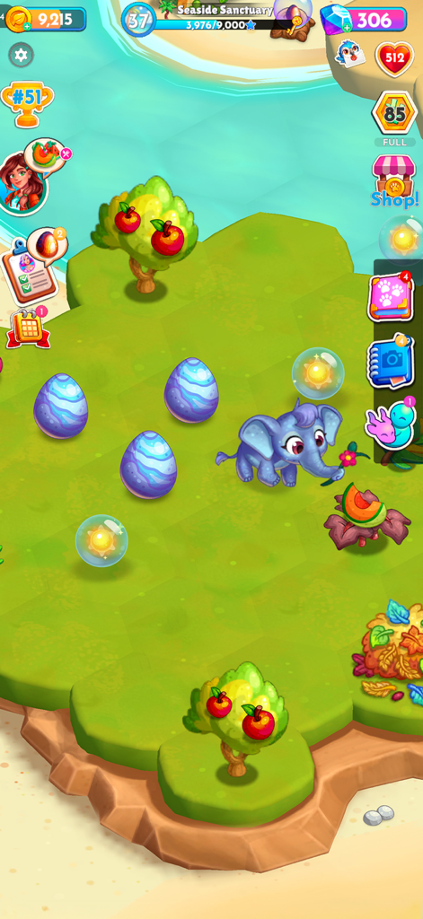 A blue baby elephant and patterned eggs on a tropical island in the game Paradise Paws