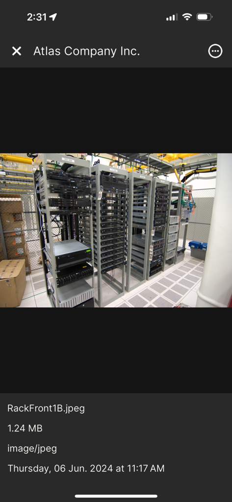 Hudu Mobile - A photo of IT server racks being viewed within the Hudu Mobile documentation app interface