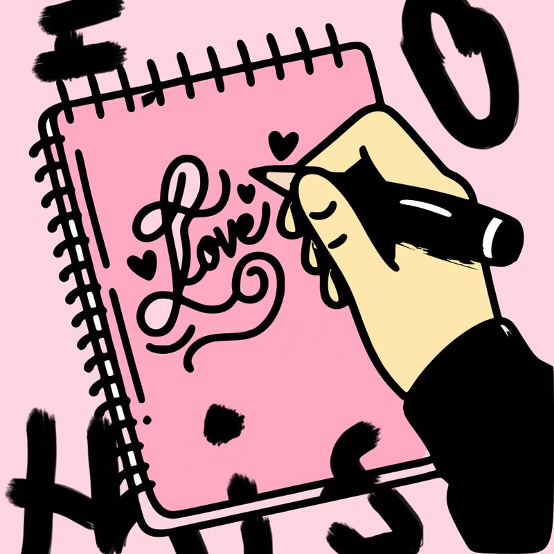 a hand writing “love” in calligraphy on a notebook