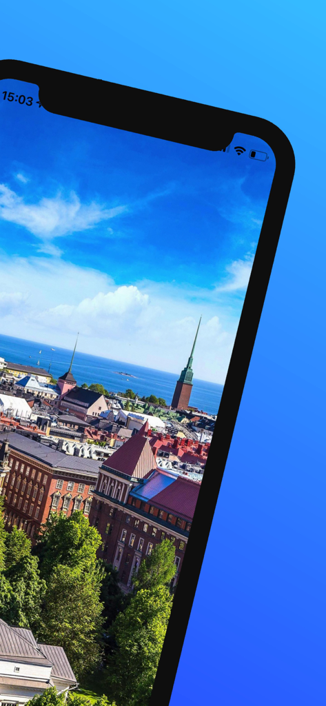 Aerial view of Helsinki cityscape featuring historic red-roofed buildings and the sea under a clear blue sky