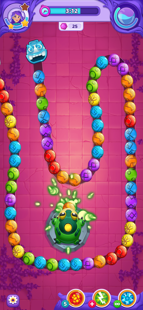 Jugabilidad de explosión de canicas con esferas coloridas y una rana lanzadora en un mundo de cuento de hadas