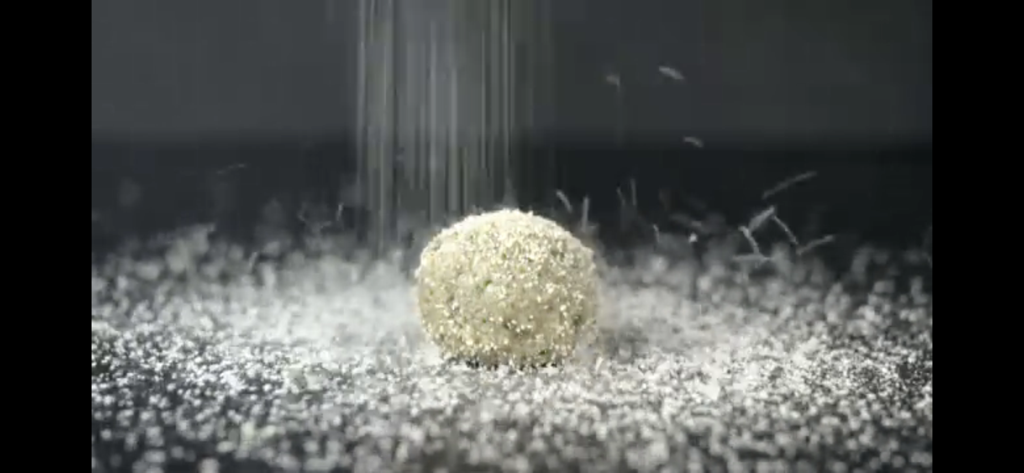 Focus & WTV - Close up of salt or sugar being sprinkled on a round food item from a Focus and WTV news segment