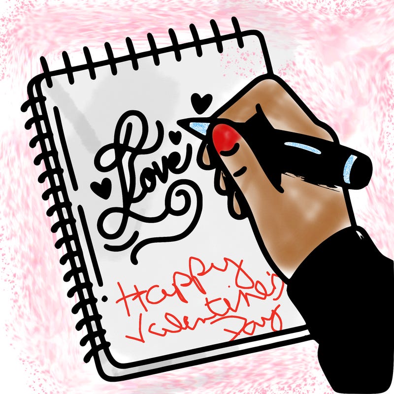 a hand writing “love” in calligraphy on a notebook