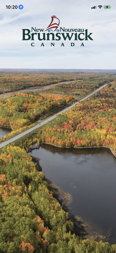 Splash screen of the 511 New Brunswick app showing an aerial view of a highway through an autumn forest with the provincial logo