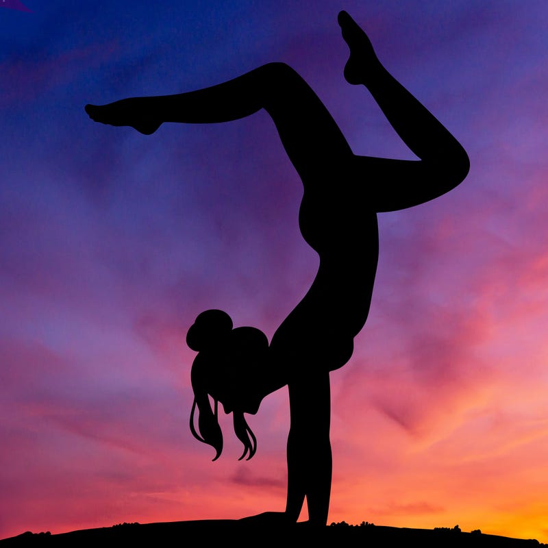 a woman doing a handstand