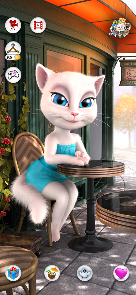 Talking Angela - Talking Angela white cat sitting at a Parisian cafe table wearing a blue dress