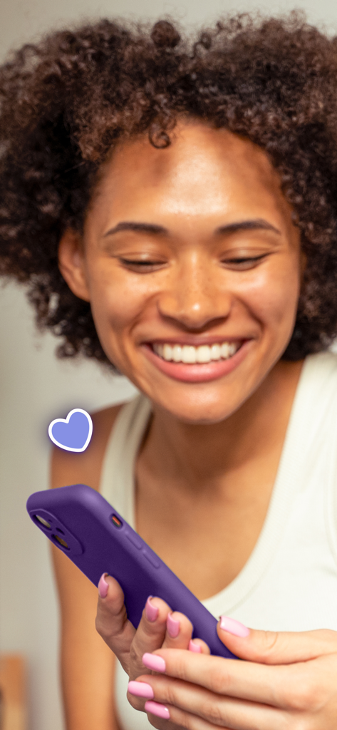 A young woman smiling while using the Blindmate social dating app on her purple smartphone.