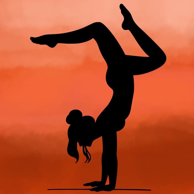 a woman doing a handstand