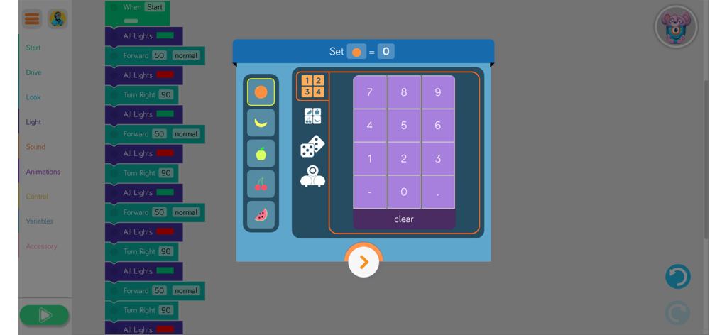 A visual programming interface in the Blockly app for Dash and Dot robots showing drag and drop code blocks and a numeric keypad for setting variables.