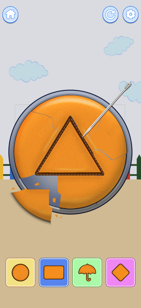 Mini Relaxing Game 2 - Un nivel de minijuego que muestra una aguja tallando un triángulo en un caramelo naranja circular