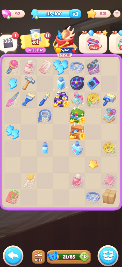 Gameplay screenshot of Merge Drama showing a puzzle grid with various items like tools and cosmetics to merge for hotel restoration