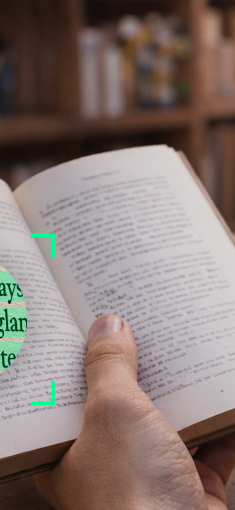 A person holding an open book with a digital scanner overlay selecting a text passage for capture