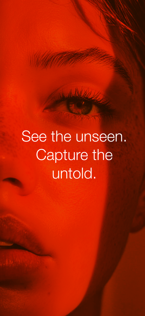 Capria - A close-up portrait of a person under a deep red light with the text See the unseen Capture the untold