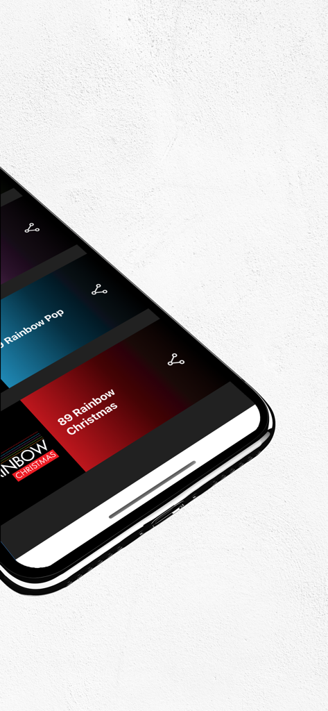 A smartphone screen displaying the 89 FM Rainbow app with various music channels like Rainbow Pop and Rainbow Christmas.