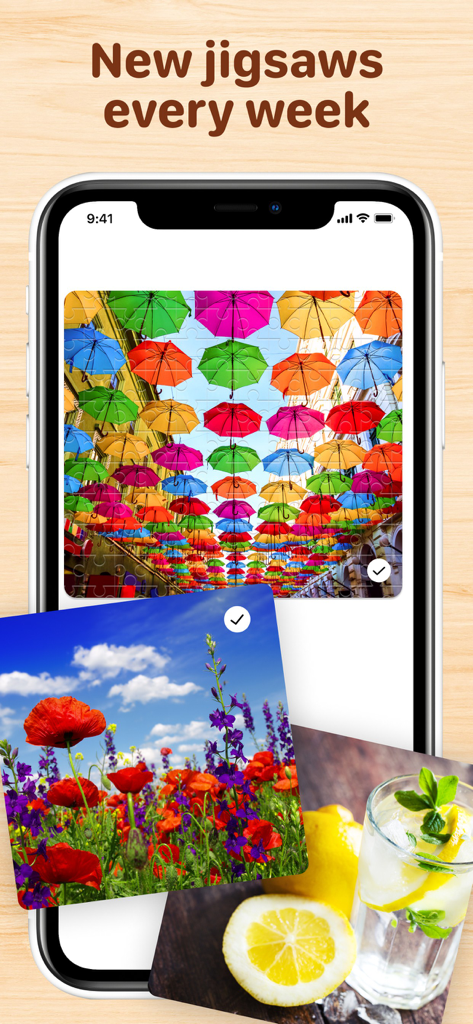 Mobile phone displaying a completed jigsaw puzzle of colorful umbrellas with a preview of nature and lifestyle puzzles